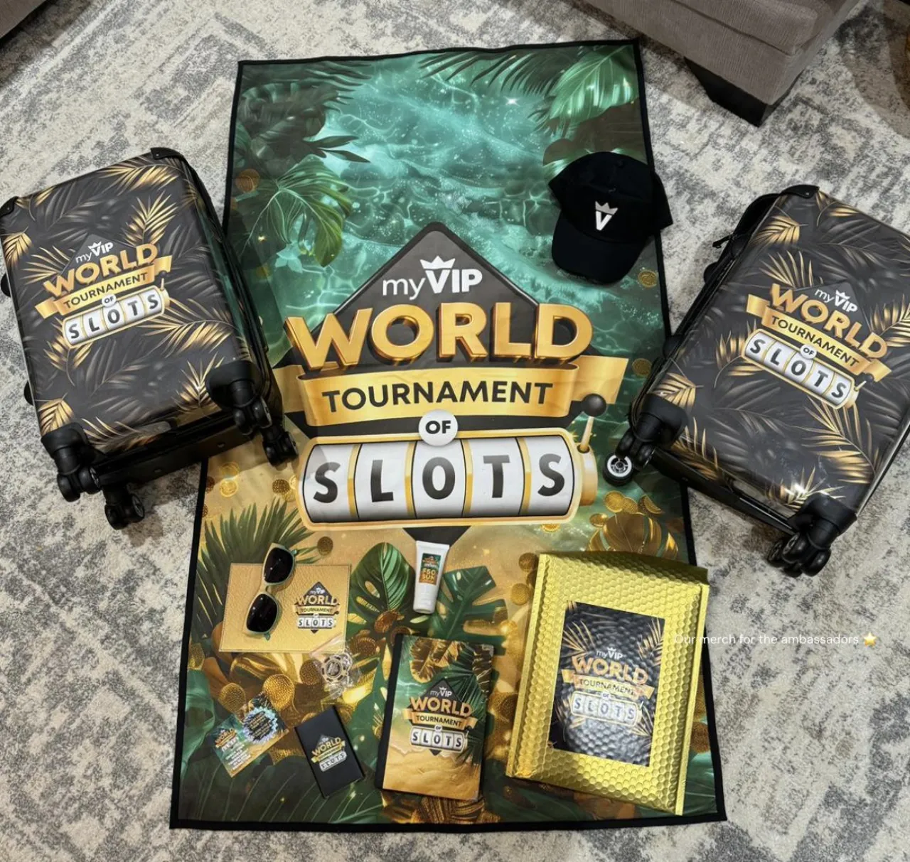 Full WTOS travel pack laid out: two branded suitcases, beach towel, sunglasses, cap, sunscreen, journal and unboxing kit.